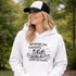 Soccer mom hoodie with “Running on Coffee and Game Day Chaos” design featuring moms cheering on the sidelines with kids playing soccer in the background