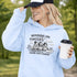 Soccer mom hoodie with “Running on Coffee and Game Day Chaos” design featuring moms cheering on the sidelines with kids playing soccer in the background