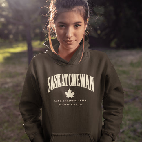 Saskatchewan Land of Living Skies unisex hoodie with vintage collegiate lettering and maple leaf graphic by Prairie Life Co.