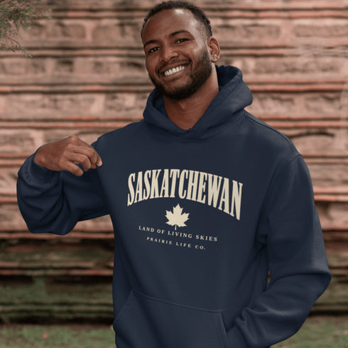 Saskatchewan Land of Living Skies unisex hoodie with vintage collegiate lettering and maple leaf graphic by Prairie Life Co.