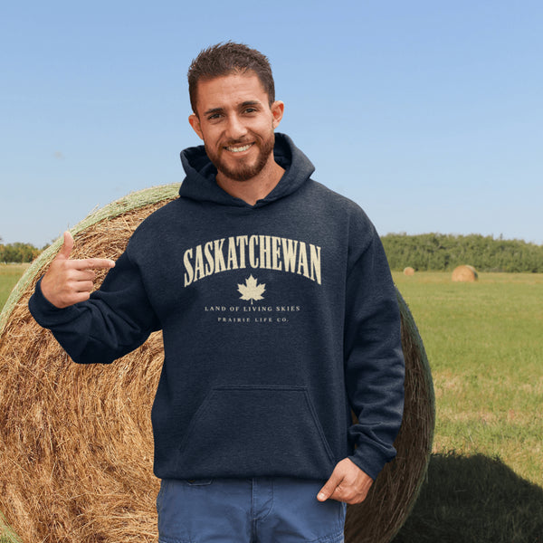 Saskatchewan Land of Living Skies unisex hoodie with vintage collegiate lettering and maple leaf graphic by Prairie Life Co.