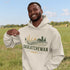 person wearing saskatchewan prairie life hoodie with farm and wheat field design standing in prairie field