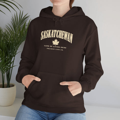 Saskatchewan Land of Living Skies unisex hoodie with vintage collegiate lettering and maple leaf graphic by Prairie Life Co.