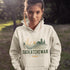 person wearing saskatchewan prairie life hoodie with farm and wheat field design standing in prairie field