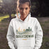 person wearing saskatchewan prairie life hoodie with farm and wheat field design standing in prairie field