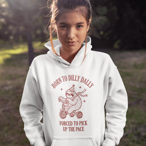 Say hello to the ultimate vibe hoodie: a chill sloth on a tricycle, rocking a party hat and scarf, paired with the painfully relatable words: "Born to dilly dally, forced to pick up the pace."