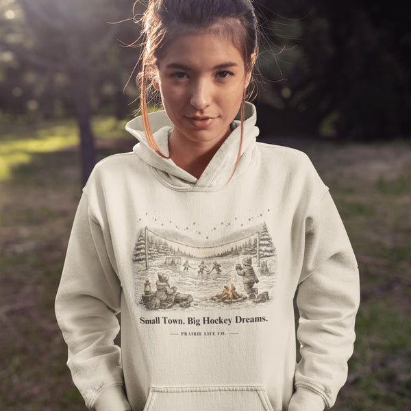 Small Town Big Hockey Dreams Hoodie – nostalgic pond hockey sweatshirt with campfire winter scene. Cozy unisex fit. Multiple colors available.