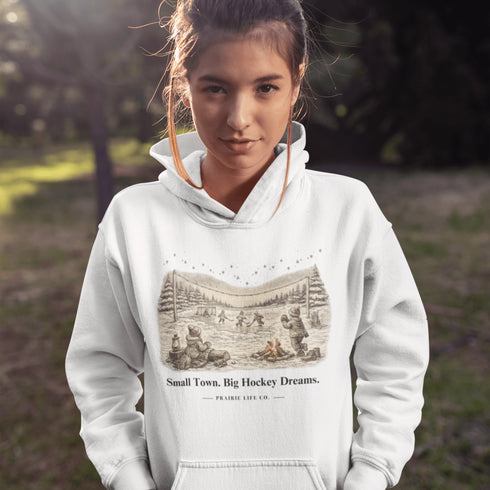 Small Town Big Hockey Dreams Hoodie – nostalgic pond hockey sweatshirt with campfire winter scene. Cozy unisex fit. Multiple colors available.