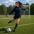 Person wearing “Soccer Nerd” hoodie holding a soccer ball on a soccer field during a game, casual athletic soccer apparel