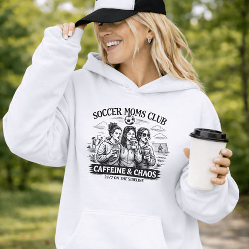 Soccer moms hoodie with “Soccer Moms Club Caffeine and Chaos” design featuring moms holding coffee cups and watching kids play soccer in the background