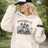 Soccer moms hoodie with “Soccer Moms Club Caffeine and Chaos” design featuring moms holding coffee cups and watching kids play soccer in the background