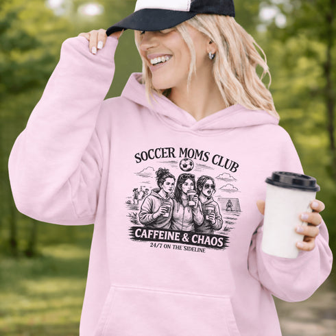 Soccer moms hoodie with “Soccer Moms Club Caffeine and Chaos” design featuring moms holding coffee cups and watching kids play soccer in the background