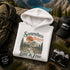 Vintage mountain adventure hoodie featuring a scenic outdoor landscape graphic on a Gildan 18500 Heavy Blend hoodie, shown in a lifestyle mockup. Available in multiple colors with a relaxed unisex fit.