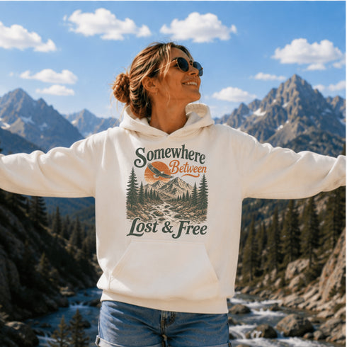 Vintage mountain adventure hoodie featuring a scenic outdoor landscape graphic on a Gildan 18500 Heavy Blend hoodie, shown in a lifestyle mockup. Available in multiple colors with a relaxed unisex fit.