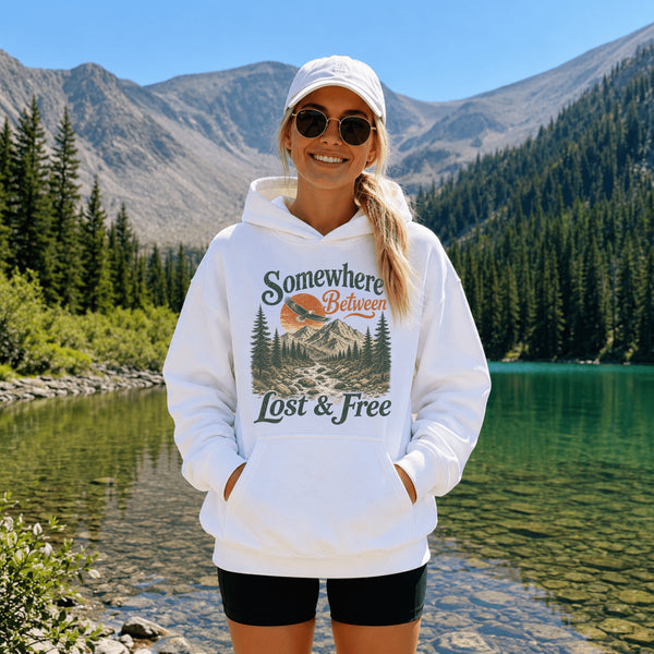 Vintage mountain adventure hoodie featuring a scenic outdoor landscape graphic on a Gildan 18500 Heavy Blend hoodie, shown in a lifestyle mockup. Available in multiple colors with a relaxed unisex fit.