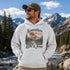 Vintage mountain adventure hoodie featuring a scenic outdoor landscape graphic on a Gildan 18500 Heavy Blend hoodie, shown in a lifestyle mockup. Available in multiple colors with a relaxed unisex fit.