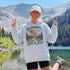 Vintage mountain adventure hoodie featuring a scenic outdoor landscape graphic on a Gildan 18500 Heavy Blend hoodie, shown in a lifestyle mockup. Available in multiple colors with a relaxed unisex fit.