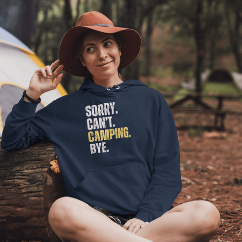 Introducing the ultimate escape gear for all the weekend warriors, the "Sorry. Can't. Camping. Bye." hoodie! This isn't just any ordinary piece of clothing; it's your ticket to avoiding all unwanted plans, chores, and responsibilities.