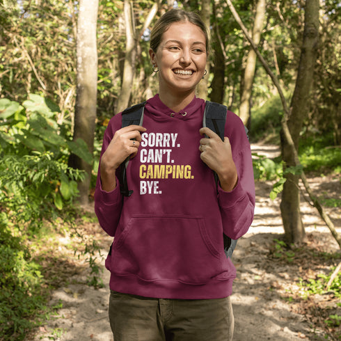 Introducing the ultimate escape gear for all the weekend warriors, the "Sorry. Can't. Camping. Bye." hoodie! This isn't just any ordinary piece of clothing; it's your ticket to avoiding all unwanted plans, chores, and responsibilities.