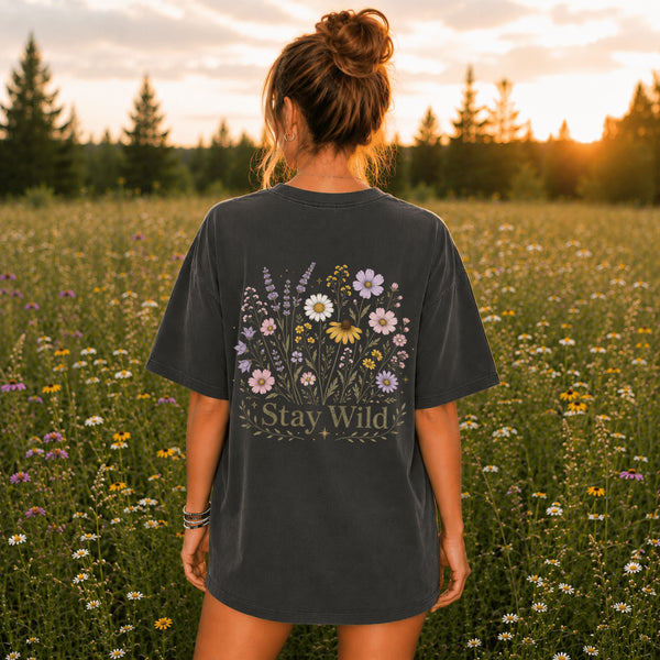 Comfort Colors® 1717 garment-dyed t-shirt featuring a vintage wildflower back graphic with coordinating left chest pocket design, shown in a lifestyle outdoor mockup. Available in multiple colors with a relaxed unisex fit.