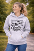 Woman wearing hoodie with goalie mom text and diving goalkeeper graphic