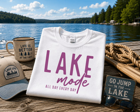 White t-shirt with 'Lake Mode' text on a dock by a lake