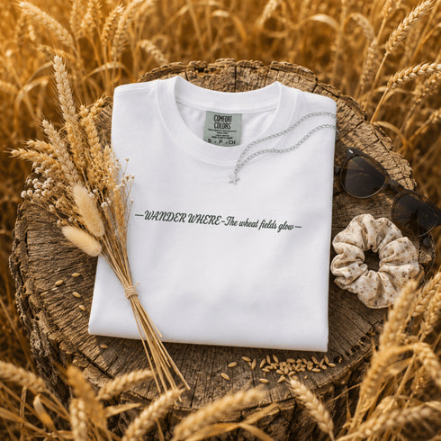 white Comfort Colors t-shirt featuring a vintage prairie road and wheat field sunset graphic on the back