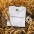white Comfort Colors t-shirt featuring a vintage prairie road and wheat field sunset graphic on the back
