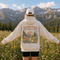 Vintage mountain and wildflower graphic hoodie featuring a matching left chest design and oversized back print on a unisex Gildan 18500 Heavy Blend hoodie available in multiple colors. Perfect for hiking, camping, outdoor adventures, and everyday wear.