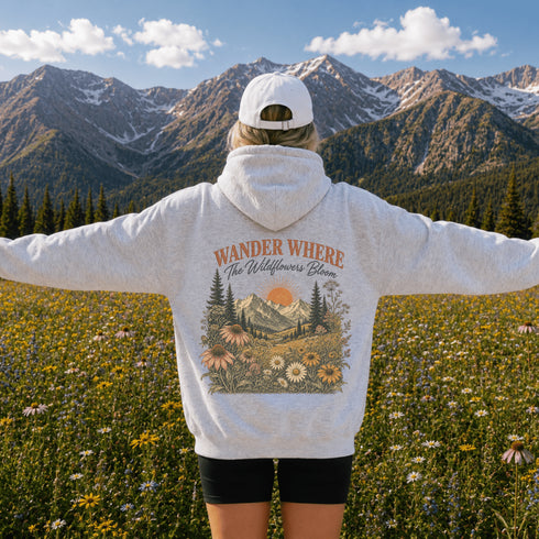 Vintage mountain and wildflower graphic hoodie featuring a matching left chest design and oversized back print on a unisex Gildan 18500 Heavy Blend hoodie available in multiple colors. Perfect for hiking, camping, outdoor adventures, and everyday wear.