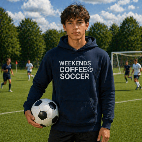 Person wearing a hoodie with 'Weekends Coffee Soccer' text on a soccer field.
