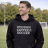 Man wearing a black hoodie with 'Weekends Coffee Soccer' text on a soccer field.