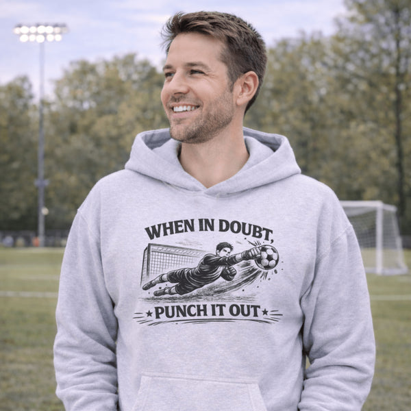 man wearing grey hoodie with “When In Doubt Punch It Out” soccer goalie design featuring diving goalkeeper making a save