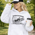 Woman wearing grey hoodie with “When In Doubt Punch It Out” soccer goalie design featuring diving goalkeeper making a save