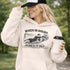 Woman wearing grey hoodie with “When In Doubt Punch It Out” soccer goalie design featuring diving goalkeeper making a save