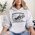 Woman wearing grey hoodie with “When In Doubt Punch It Out” soccer goalie design featuring diving goalkeeper making a save