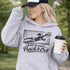 woman wearing hoodie with “When In Doubt Punch It Out” soccer goalie design featuring diving goalkeeper making a save in front of net