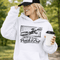 woman wearing hoodie with “When In Doubt Punch It Out” soccer goalie design featuring diving goalkeeper making a save in front of net
