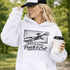 woman wearing hoodie with “When In Doubt Punch It Out” soccer goalie design featuring diving goalkeeper making a save in front of net