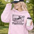 woman wearing hoodie with “When In Doubt Punch It Out” soccer goalie design featuring diving goalkeeper making a save in front of net
