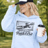 woman wearing hoodie with “When In Doubt Punch It Out” soccer goalie design featuring diving goalkeeper making a save in front of net