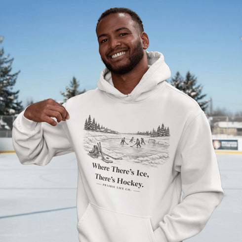 Stay warm and playful with our Winter Pond Hockey Hoodie. Featuring kids playing on a frozen pond, snowy trees, country houses, and the motto “If There's Ice, There's Hockey” – perfect for hockey fans and winter lovers.