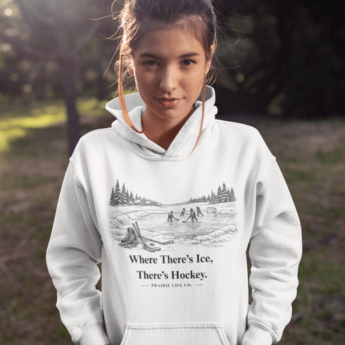 Stay warm and playful with our Winter Pond Hockey Hoodie. Featuring kids playing on a frozen pond, snowy trees, country houses, and the motto “If There's Ice, There's Hockey” – perfect for hockey fans and winter lovers.