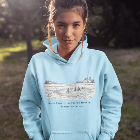 Celebrate the magic of winter with our Winter Pond Hockey Hoodie. Featuring kids playing hockey on a frozen pond, a rustic barn, snowy trees – perfect for hockey moms, fans, and winter lovers.
