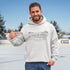 Celebrate the magic of winter with our Winter Pond Hockey Hoodie. Featuring kids playing hockey on a frozen pond, a rustic barn, snowy trees – perfect for hockey moms, fans, and winter lovers.