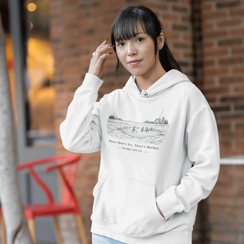 Celebrate the magic of winter with our Winter Pond Hockey Hoodie. Featuring kids playing hockey on a frozen pond, a rustic barn, snowy trees – perfect for hockey moms, fans, and winter lovers.