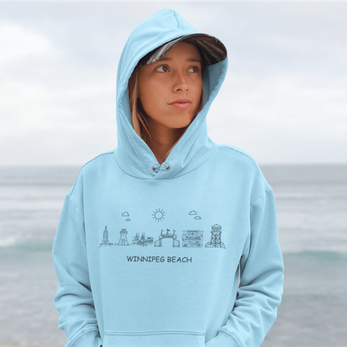 Show off your lake town pride with this cozy Winnipeg Beach Landmark Doodle Hoodie. Featuring a charming, hand-drawn skyline of iconic Winnipeg Beach sights.