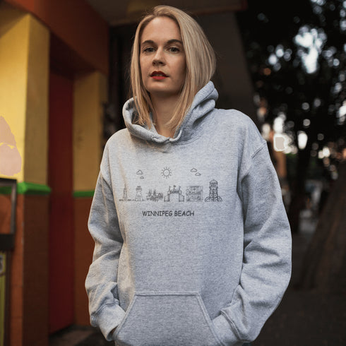 Show off your lake town pride with this cozy Winnipeg Beach Landmark Doodle Hoodie. Featuring a charming, hand-drawn skyline of iconic Winnipeg Beach sights.