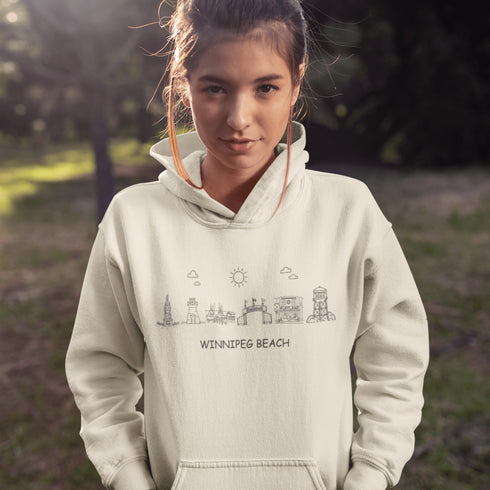 Show off your lake town pride with this cozy Winnipeg Beach Landmark Doodle Hoodie. Featuring a charming, hand-drawn skyline of iconic Winnipeg Beach sights.
