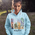 Bring the peaceful charm of Winnipeg Beach with you wherever you go. This soft, comfortable hoodie features a watercolor-style collage celebrating the beauty of Manitoba’s cherished lakeside town.